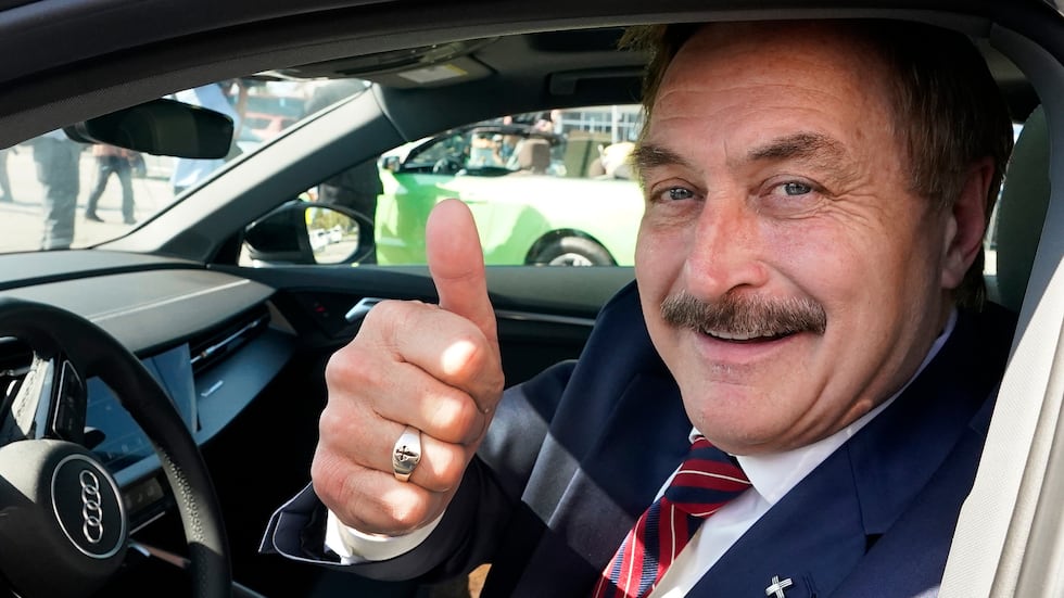FILE - Mike Lindell gives a thumbs up as he passes by a rally for supporters of former...