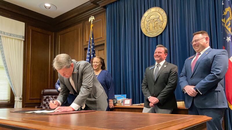 Georgia Gov. Brian Kemp signs a bill to give state income refunds of more than $1.1 billion on...