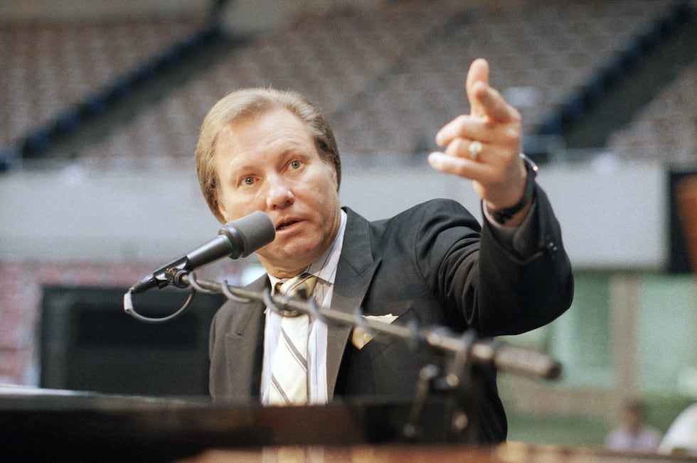 Rev. Jimmy Swaggart raises his fist to make point at news conference at the Sports Arena in...