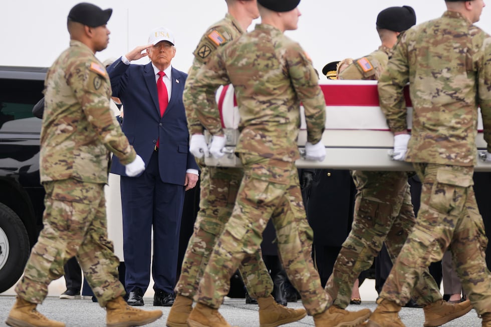 An Army carry team moves a flag-draped transfer case with the remains of U.S. Army Reserve...