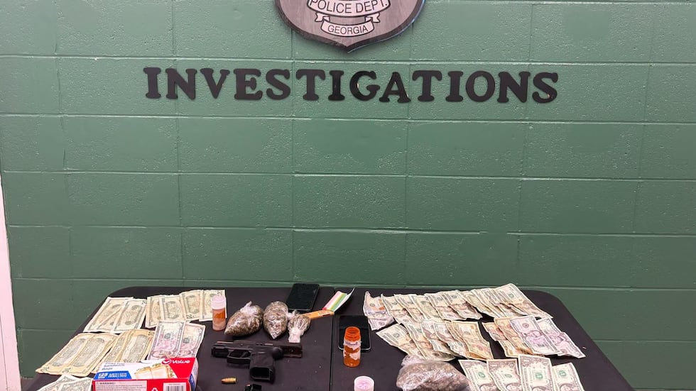 Illegal drugs, stolen firearm recovered during Dawson traffic stop, police say