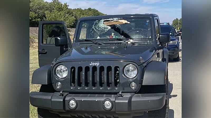 An 18-year-old driver in Kansas says a board fell off a truck and went through her windshield.