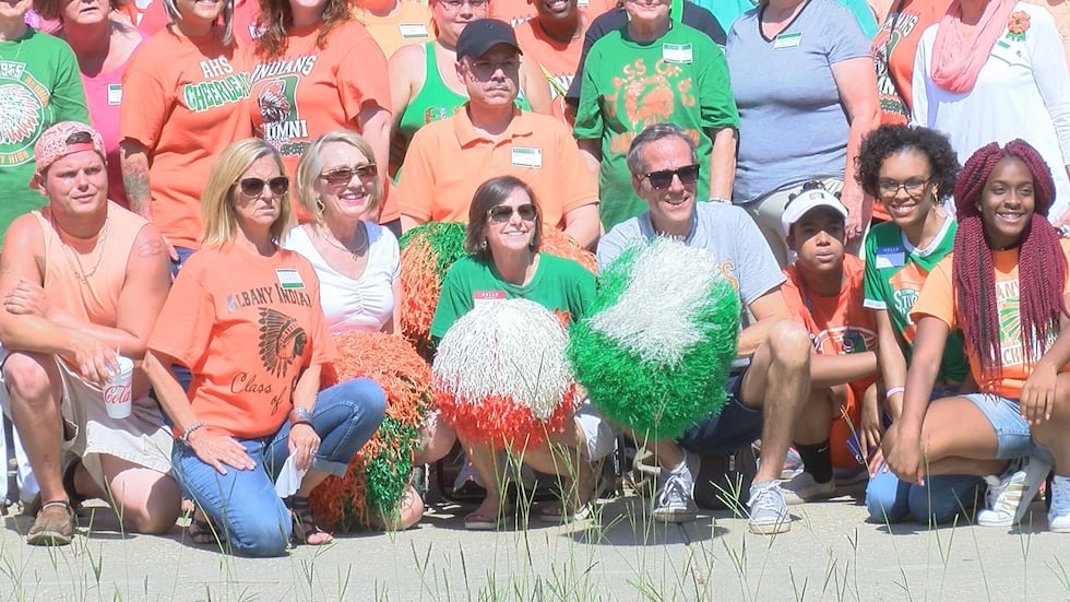 Alumni and now former students donned their orange and green to show their pride in a picture....