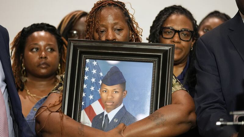 Chantemekki Fortson, mother of Roger Fortson, holds a photo of her son during a news...