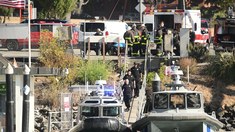 Emergency crews gather at a dock near the site of a pontoon boat fire on Tuesday, July 14,...