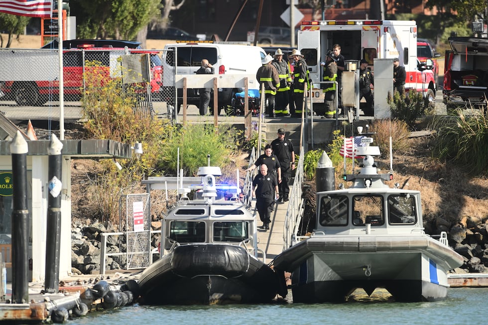 Emergency crews gather at a dock near the site of a pontoon boat fire on Tuesday, July 14,...