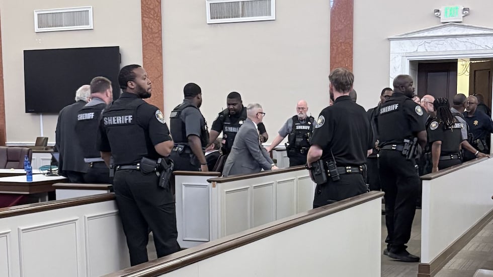 Michael Nix pictured, surrounded by deputies, moments after a jury found him guilty on all...