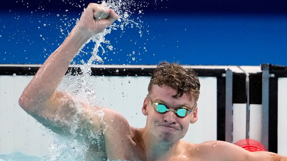 Leon Marchand, of France, celebrates after winning the men's 200-meter breaststroke final at...