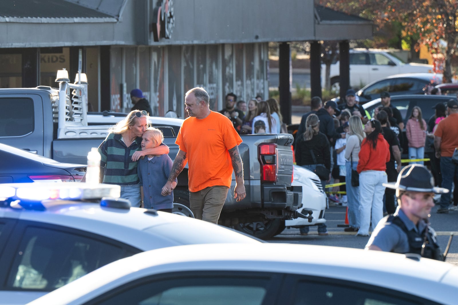 People leave a family meeting area following a shooting at Silver Rail Elementary School,...