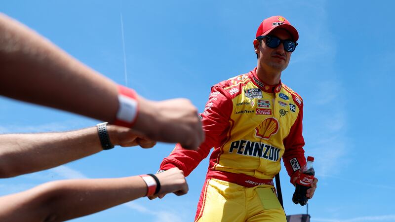 Driver Joey Logano greets fans before a NASCAR Cup Series auto race at Talladega...