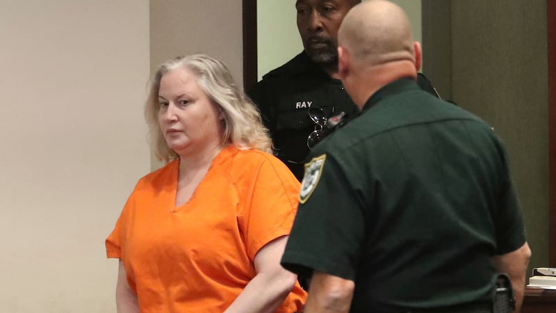 WWE Hall of Famer Tammy Sytch is escorted to the defense table by Volusia County Sheriff's...