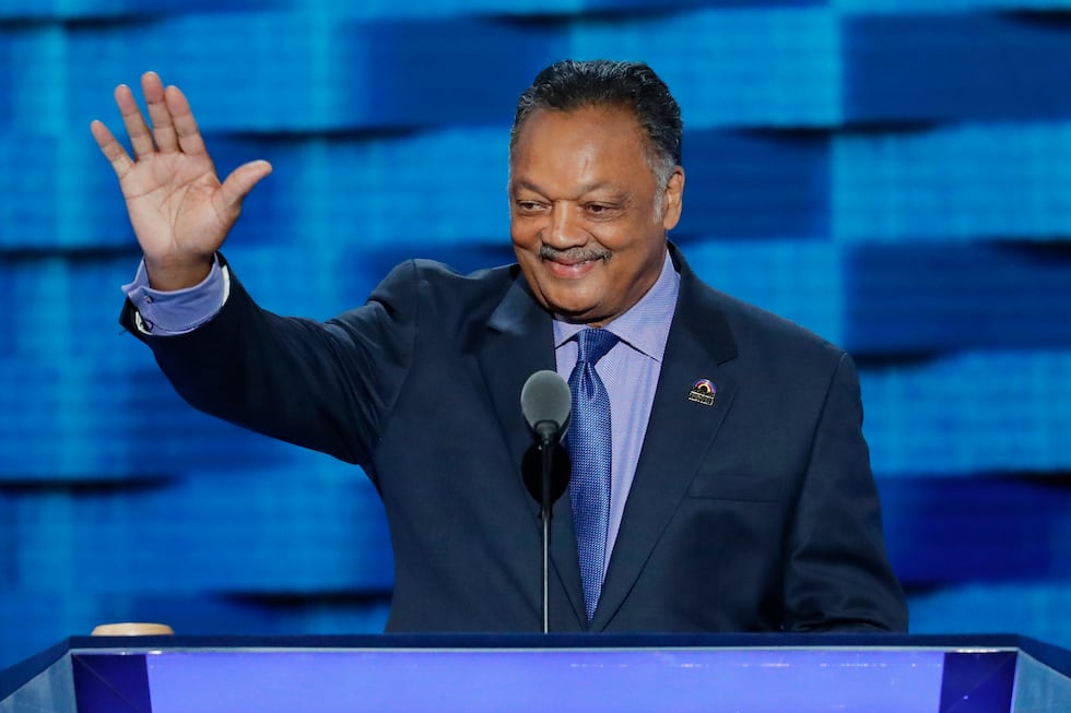 FILE - Rev. Jesse Jackson waves as he steps to the podium during the third day of the...