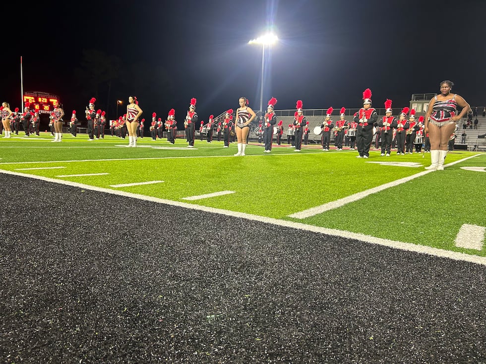 The marching band pauses for a moment of silence and reflection after the passing of Joe Ward.