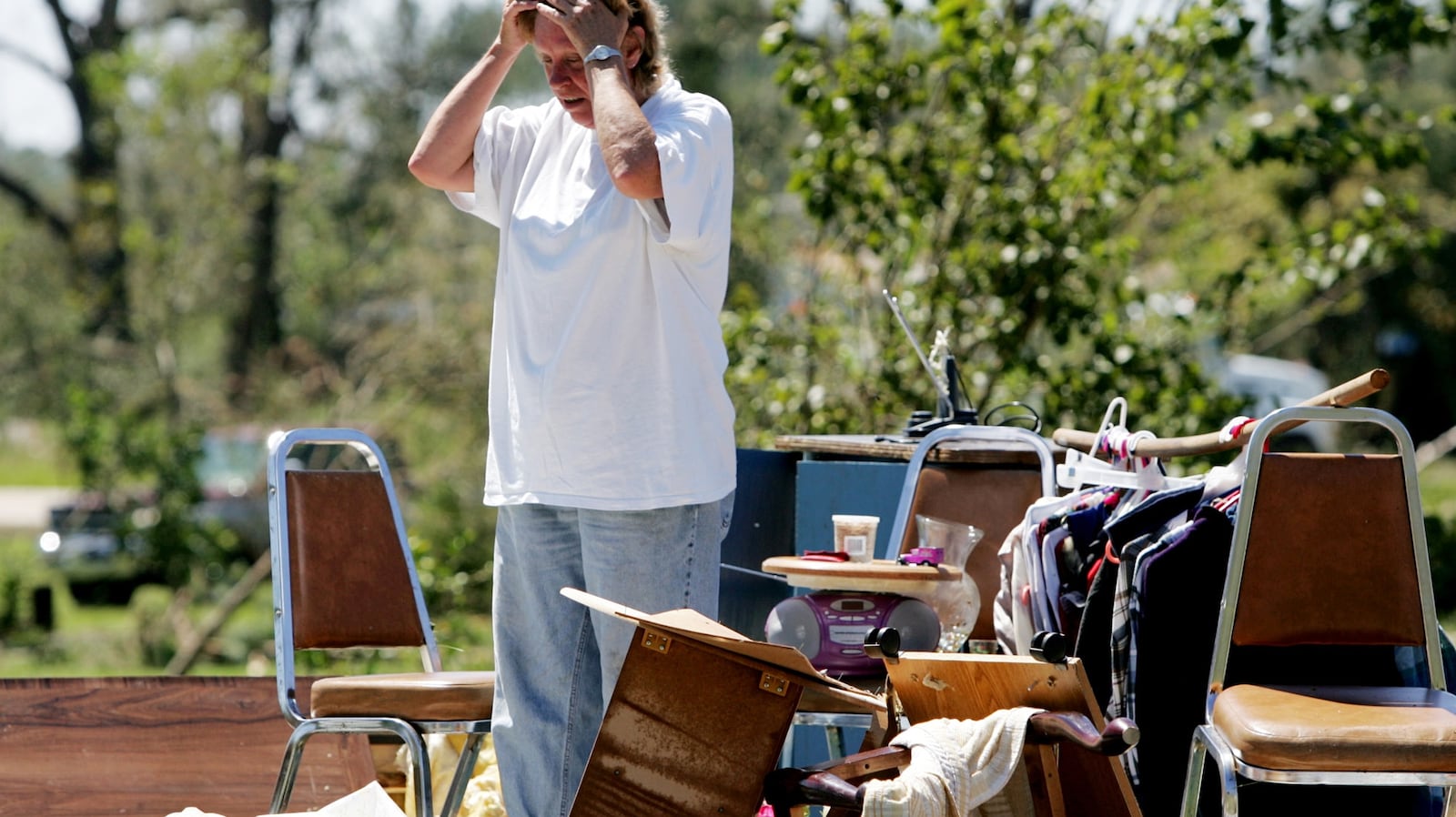 FILE - Edie Kearns stands on the floor of her home that was destroyed by a tornado associated...