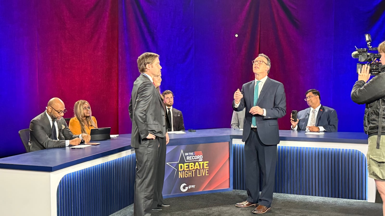 Atlanta News First's Rick Folbaum (right) conducts the coin toss with surrogates from the Jon...