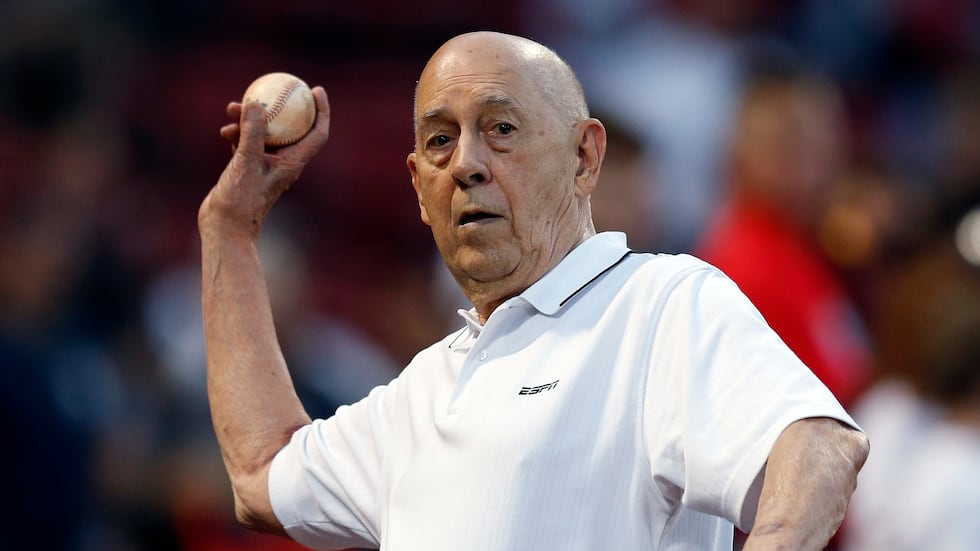 Founder of ESPN Bill Rasmussen tosses a ball before a baseball game between the Boston Red Sox...