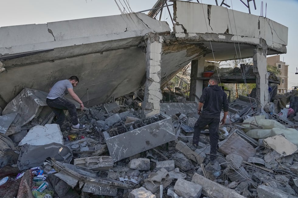 People check a house where multiple family members were killed by an Israeli airstrike, in...