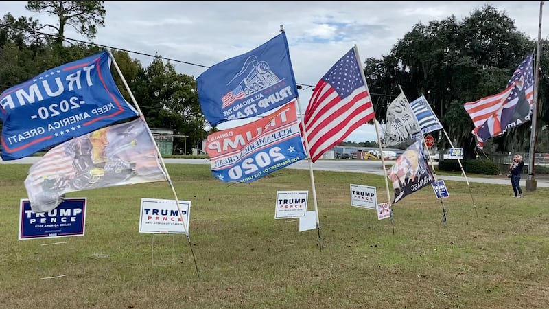 Trump signs in front of the airport for his visit.