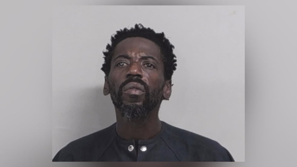Ezzie Smith, 49, was carrying what appeared to be a long gun by his side.