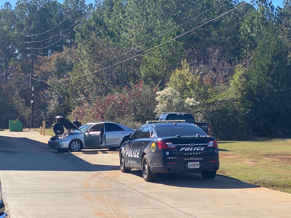 Photo of Lee County deputies and ALbany police searching the suspect's car in Albany