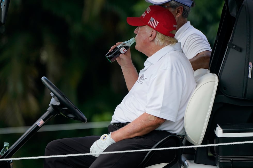 FILE - Former President Donald Trump drinks a Diet Coke during the ProAm of the LIV Golf Team...