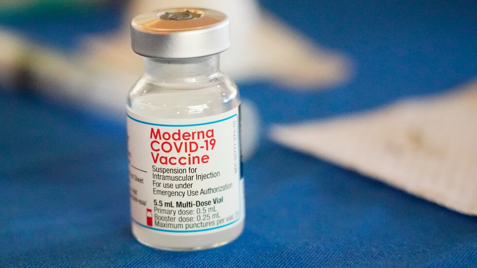 FILE - A vial of Moderna COVID-19 vaccine rests on a table at an inoculation station in...